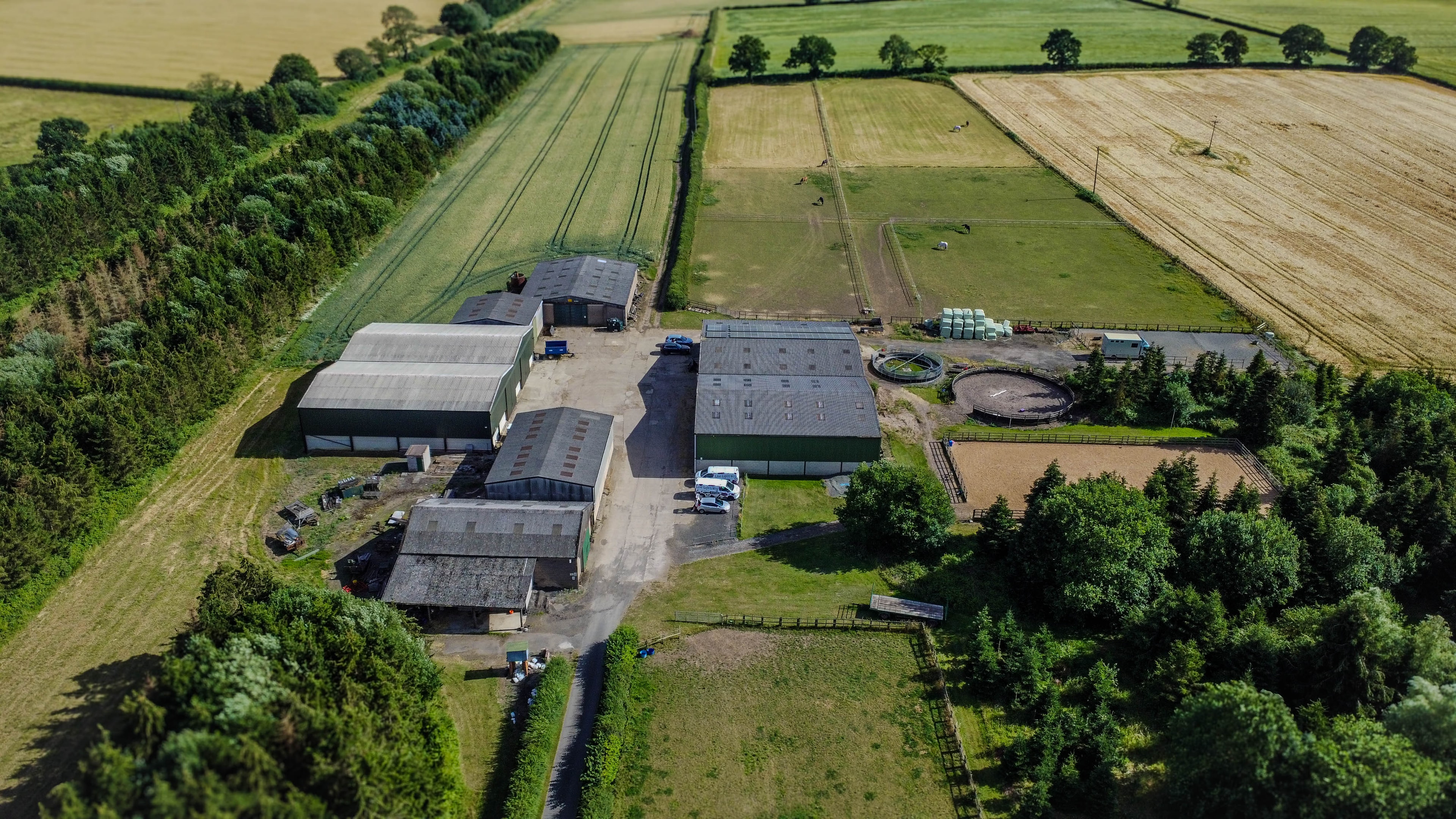 Aerial view of farm complex with agricultural buildings