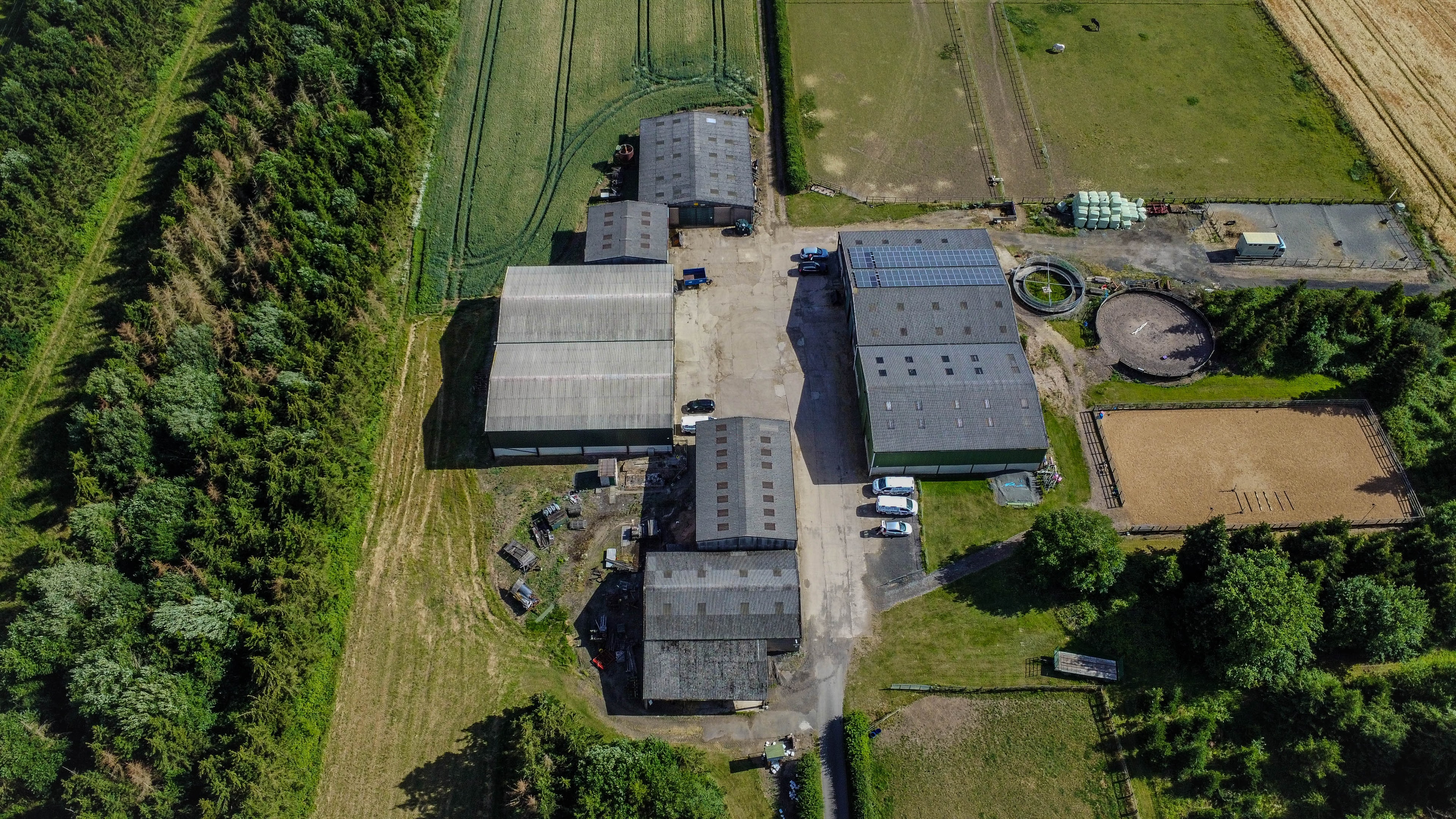Aerial view of farm buildings with solar panels
