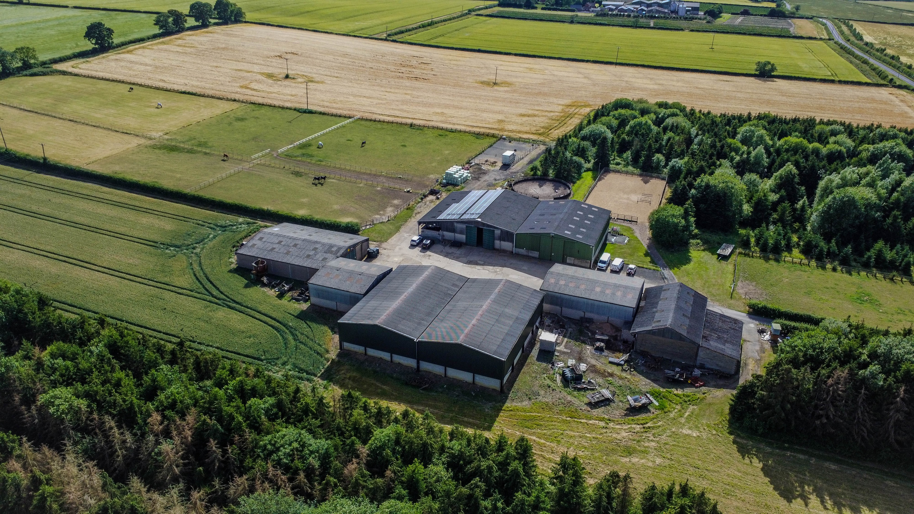 Aerial view of farm facility with solar panels and surrounding fields